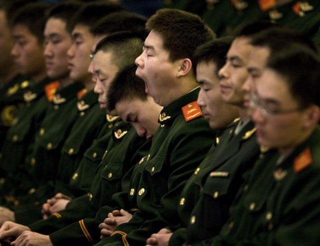 A Chinese paramilitary police yawns and his colleagues sleep while President Hu Jintao, unseen, delivers a speech on a celebration to mark the 30th anniversary of China's reform held at the Great Hall of the People in Beijing, China, Thursday, Dec. 18, 2008. Thirty years ago this month, China's communist leaders launched an economic revolution, opening the door to free market reforms and foreign trade though not to political change. The party marked the anniversary Thursday with a ceremony in the Great Hall of the People, opening with a speech from Hu Jintao, general secretary of the party and China's president. (AP Photo/Andy Wong)