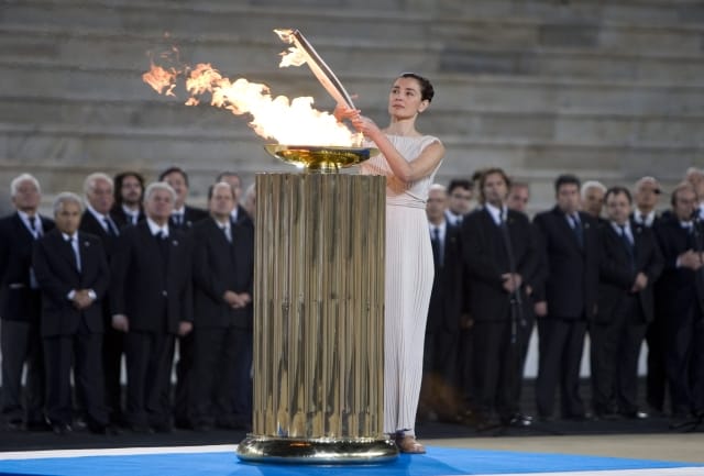 Greek actress Maria Nafpliotou, who plays the role of high priestess, lights the torch during a ceremony at the Panathenian Stadium, where the first modern Games were held in 1896, in Athens Thursday, Oct. 29, 2009. After an eight-day trip through Greece, the flame will be flown to Canada for a 28,000-mile journey which organizers say will be the largest national relay. (AP Photo/The Canadian Press, Jonathan Hayward)