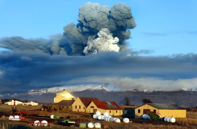 The volcano in southern Iceland's Eyjafjallajokull glacier sends ash into the air just prior to sunset Friday, April 16, 2010. Thick drifts of volcanic ash blanketed parts of rural Iceland on Friday as a vast, invisible plume of grit drifted over Europe, emptying the skies of planes and sending hundreds of thousands in search of hotel rooms, train tickets or rental cars. (AP Photo/Brynjar Gauti)