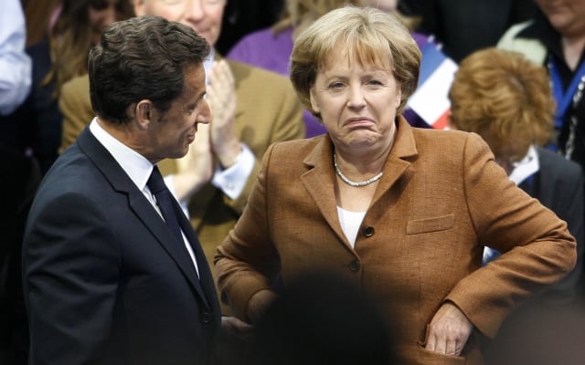 German Chancellor Angela Merkel, right, and French President Nicolas Sarkozy, left, attend a German-French friendship meeting,, of the Jungen Union, the youth organization of Germany's Christian Democrats, in Berlin on Sunday, May 10, 2009. (AP Photo/Markus Schreiber) =@=