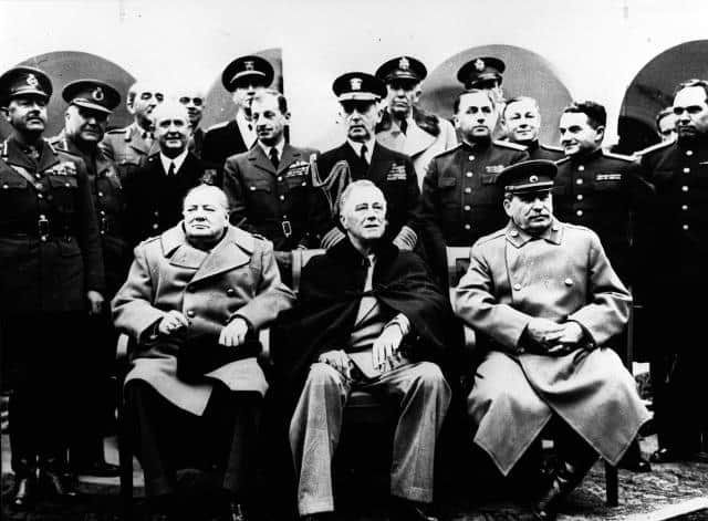 British Prime Minister Winston Churchill, front left, U.S. President Franklin D. Roosevelt, center, and Soviet Premier Joseph Stalin attend the Big Three Conference at the Livadia Palace in Yalta on February 12, 1945. Behind those seated, from left: Field Marshall Sir Harold Alexander, Field Marshall Sir Henry Maitland Wilson, Field Marshall Sir Alan Brooke, Admiral of the Fleet Sir Alan Cunningham, Gen. Sir Hastings Ismay, Fleet Admiral E.J. King and Air Chief Marshall Sir Charles Portal. Others are not identified. The meeting in Russia's Crimea, now Ukraine, determined the shape of postwar East and Central Europe, making the Soviet Union dominant in eastern Europe. The Big Three powers reached agreements that changed the course of world events.
