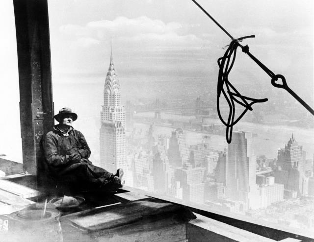 With the Chrysler Building to his left, a steel worker rests on a girder at the 86th floor of the new Empire State Building during construction in New York City, in this Sept. 24, 1930 file photo. Born in the Great Depression, it has weathered economic hardship, world war, labor strikes, murder, terrorist fears and yes, even its own plane crash. On Monday, May 1, 2006, the Empire State Building turns 75 years old, a diamond jubilee for New York City's crown jewel. (AP Photo, File)