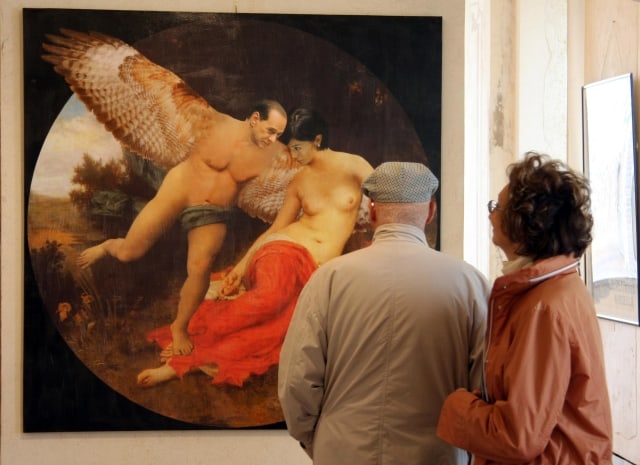 An unidentified couple, at right, looks at an artwork by Filippo Panseca, depicting Italian Premier Silvio Berlusconi with a giant pair of wings and little else, at left, with an equally topless female minister of his government Mara Carfagna, in Savona's museum, northern Italy, Tuesday April 21, 2009. I did it as a joke! the artist, Filippo Panseca, told The Associated Press on Tuesday. I've been doing all sorts of works for 50 years, I didn't expect to raise such clamor with this. The work is all the more controversial because the minister portrayed next to the Italian premier, Mara Carfagna, had been on the receiving end of a Berlusconi compliment two years ago. If I weren't married I would marry you immediately, Berlusconi reportedly said to the woman, a 33-year-old former TV starlet who currently serves as minister for equal opportunities. The comment at the time enraged Berlusconi's wife, who publicly demanded an apology. (AP Photo/Italo Banchero)