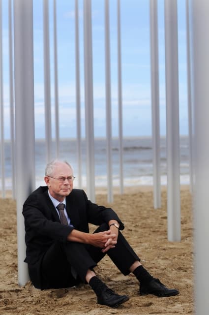 Herman Van Rompuy leans against an artwork on the beach at the Beaufort art installation in De Haan, Belgium on 8 July 2009._ (Photo by Ivan Put)