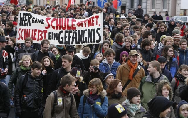 About 3,000 students protest in Bonn, Germany for another education policy on Thursday, Dec. 10, 2009. The poster reads: Opening a school means closing a prison. (AP Photo/Hermann J. Knippertz) =@=