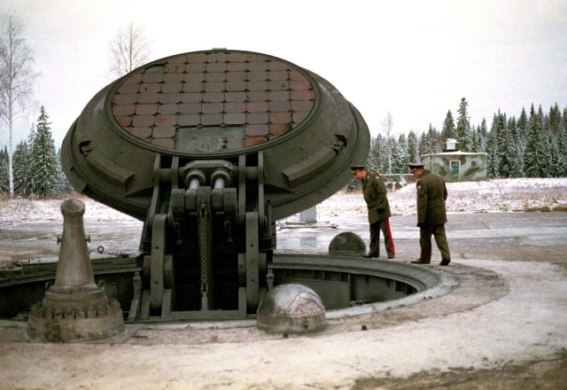 *** FILE *** Russian high ranking military officials, look into an opened silo of a Russian intercontinental ballistic Topol-M missile somewhere at undisclosed location in Russia in this 2001 photo. Russia's Defense Minister Sergei Ivanov said in a speech before lawmakers that the plan envisages the deployment of the total of 34 new silo-based Topol-M missiles and their control units, as well as another 50 such missiles mounted on mobile launchers through 2015; Russia so far has deployed more than 40 silo-based Topol-Ms. (AP Photo) 