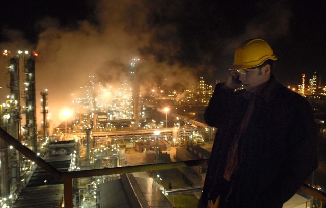 An engineer uses his mobile phone in the refinery plant at the receiving station of the oil pipeline Friendship or Druzhba in Szazhalombatta, 29 kms south of Budapest, Hungary, Monday night, Jan. 8, 2007, after the oil delivery the crude oil delivery to Hungary from Russia was halted due to a pricing dispute between Russia and Belarus. Hungarian Minister of Economics Janos Koka said he would order the release of Hungary's strategic oil reserves, enough for 90 days, if deliveries from Russia were not restarted within 24 hours. (AP Photo/MTI, Laszlo Beliczay)