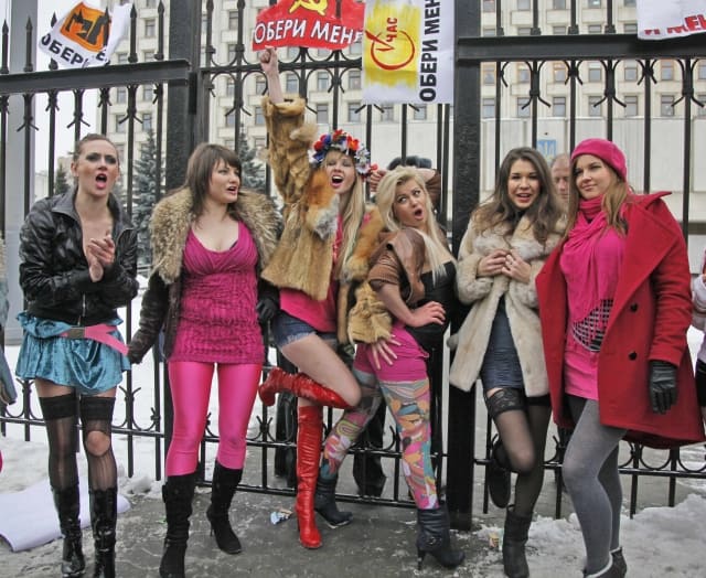 Activists of the Women's Movement ?FEMEN?, dressed as prostitutes, take part in a rally outside the Central Election Commission office in Kiev, Ukraine, Thursday, Jan. 14, 2010. The event was meant to highlight what the group called political prostitution and crude populism in the election campaign. The posters with the logos of the leading candidates and signature 