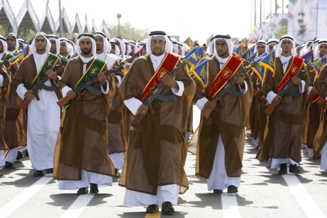 A group of Iranian Arabs, who are members of Basij militia, affiliated to the Revolutionary Guard, march during a military parade ceremony marking the 29th anniversary of the start of the 1980-1988 Iraq-Iran war, in front of the mausoleum of late revolutionary founder Ayatollah Khomeini, just outside Tehran, Iran, Tuesday, Sept. 22, 2009. (AP Photo/Vahid Salemi)