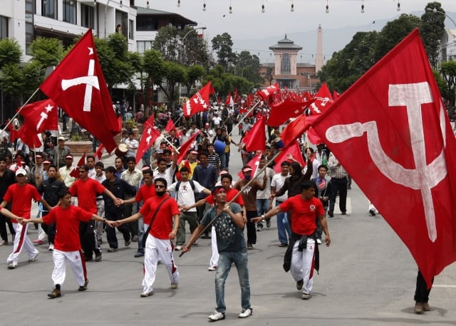 Supporters of the Communist Party of Nepal (Maoist) stage a street march protesting President Ram Baran Yadav rejecting the ouster of the army chief, who had resisted the integration of the former rebel fighters into the military as required under a 2006 peace agreement, in Katmandu, Nepal, Sunday, May 17, 2009. An alliance of 22 political parties claimed Sunday to have enough support to form a new coalition government in Nepal and called for a vote to elect its candidate as the new prime minister, officials said. (AP Photo/ Binod Joshi) 