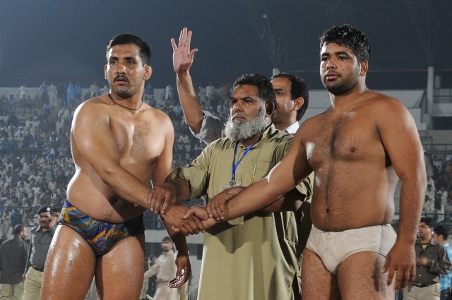 Indian wrestler Sutandar Singh,( lift), shake hand with (right) Pakistani wrestler Shahid Khoyawala during a friendly bout Sutandar Singh defeated Shahid Khoyawala in the match which was organized in an effort to 'normalize' relations between Pakistan and India in Lahore, Pakistan on November 21, 2011. Photo Irfan Ali/ABACAUSA.COM