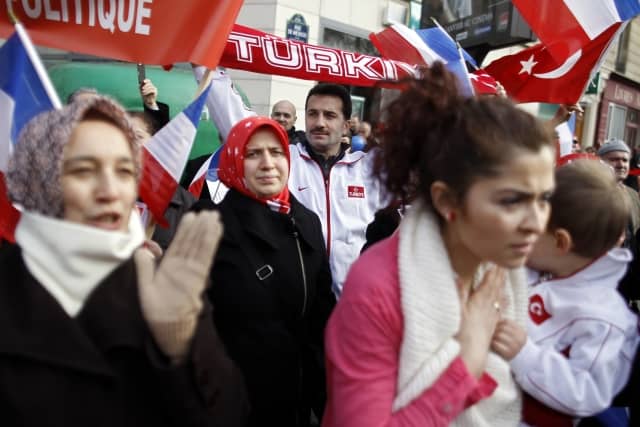 Turkish citizens in France demonstrate in front of the Senate in Paris, Monday Jan. 23, 2012, to protest against a law that would make it a crime to deny 