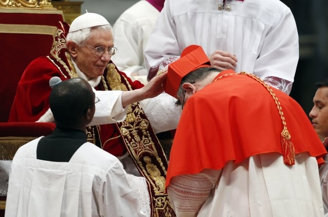 Newly-elected Cardinal, Archbishop of Prague Dominik Duka, of the Czech Republic, receives his biretta hat from Pope Benedict XVI during his elevation inside the St. Peter's Basilica at the Vatican, Saturday, Feb. 18, 2012. Pope Benedict XVI on Saturday brought 22 new Catholic churchmen into the elite club of cardinals who will elect his successor, in a greatly simplified ceremony that took account of evidence the 84-year-old pontiff is slowing down. (AP Photo/Andrew Medichini) 